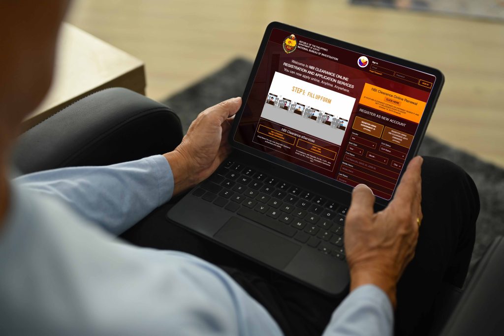 Senior man sitting on the armchair and using digital tablet. Elderly people lifestyle and technology concept.